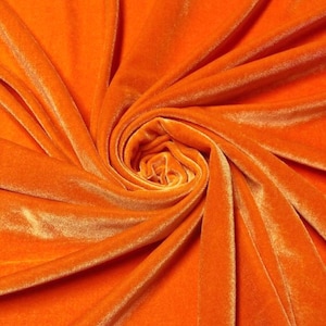May include: Close-up of a bright orange velvet fabric, showing the soft texture and rich color.