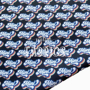 May include: Black fabric with a repeating pattern of the word "Mini" in a retro rainbow font.