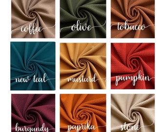 May include: Nine fabric swatches in various colors, including coffee, olive, tobacco, new teal, mustard, pumpkin, burgundy, paprika, and stone. Each swatch is folded in a spiral shape.