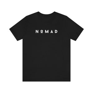 May include: Black t-shirt with the word "NOMAD" printed in white on the front.