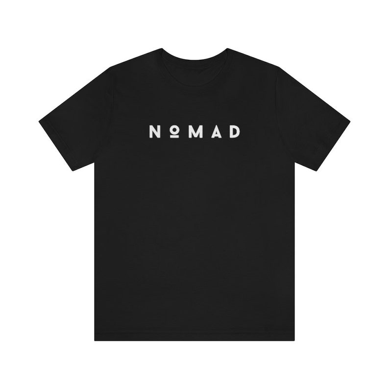 May include: Black t-shirt with the word "NOMAD" printed in white on the front.