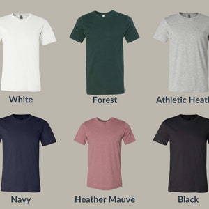 May include: Six different color t-shirts, including white, forest green, athletic heather, navy, heather mauve, and black.