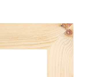 Könnte beinhalten: Nahaufnahme einer Ecke eines hellen Holzrahmens. Die Holzmaserung ist sichtbar, und in der Ecke befindet sich ein Astloch. Der Rahmen ist unfertig und einsatzbereit.