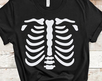 May include: Black t-shirt with a white skeleton ribcage graphic printed on the front. The shirt is made of a soft, comfortable material and is perfect for Halloween.