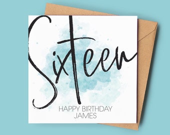 May include: A white card with a blue watercolor background and black calligraphy that says "Sixteen" with the text "Happy Birthday James" below.