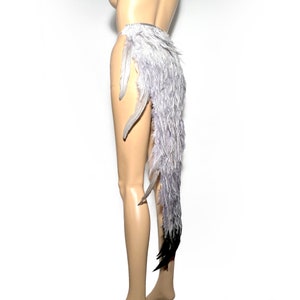 May include: A gray and black feather tail costume accessory. The tail is made of feathers and is attached to a belt. The tail is about 30 inches long.