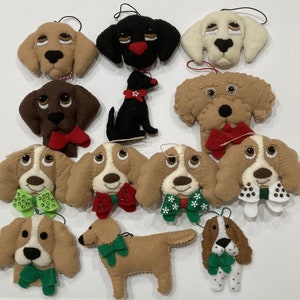 May include: Twelve felt Christmas ornaments shaped like dogs, each with a different breed and wearing a festive bow tie. The ornaments are in various colors, including brown, black, white, and tan.