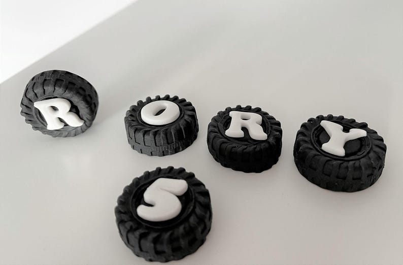 a collection of black and white tire-shaped objects, with the word "RORY" spelled out using the tires.