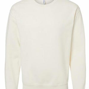 May include: Cream-colored sweatshirt with a crew neck and long sleeves. The garment has a ribbed hem and cuffs. The fabric appears to be a soft, medium-weight material. The overall style is casual and comfortable.