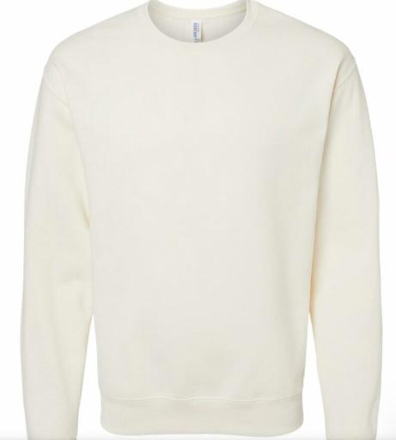 May include: Cream-colored sweatshirt with a crew neck and long sleeves. The garment has a ribbed hem and cuffs. The fabric appears to be a soft, medium-weight material. The overall style is casual and comfortable.
