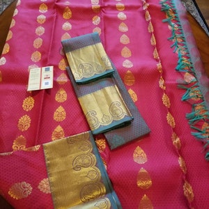 Pure Kanchipuram silk saree in a stunning red color with big woven zari buttas and green border.  SILK MARK CERTIFIED.