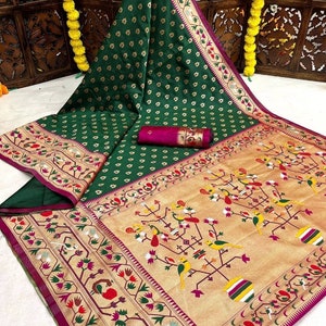 Paithani saree in a beautiful jewel green color with richly woven traditional muniya borders and pallu. Stitched blouse included. Grand sari