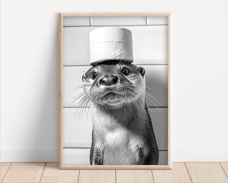 May include: A black and white photo of an otter wearing a toilet paper roll as a hat. The otter is looking directly at the camera.