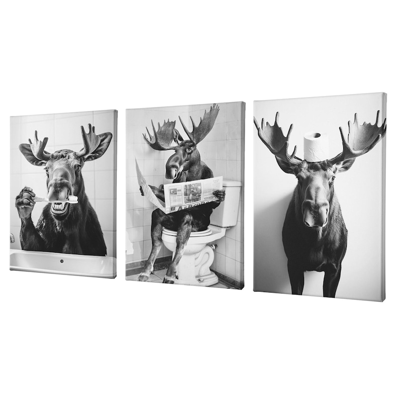 May include: A set of three black and white canvas prints featuring a moose in different humorous situations. The first print shows a moose brushing its teeth, the second shows a moose reading a newspaper on the toilet, and the third shows a moose sitting on the toilet with toilet paper on its head.