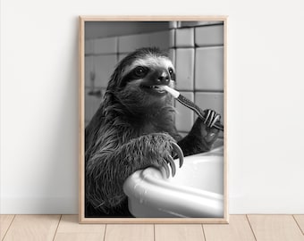 May include: A black and white photograph of a sloth brushing its teeth with a toothbrush. The sloth is sitting in a white sink and has a serious expression on its face.