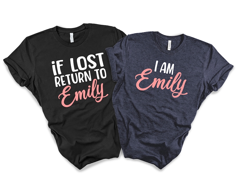 May include: Two t-shirts, one black and one navy blue, with a matching design. The black t-shirt says "if lost return to Emily" in white text with "Emily" in pink. The navy blue t-shirt says "I am Emily" in white text with "Emily" in pink.