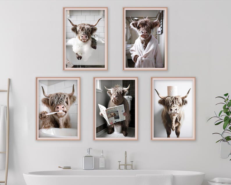 May include: Five framed prints featuring Highland cows in humorous bathroom scenes. One cow is in a bathtub, another in a bathrobe, a third brushing its teeth, a fourth reading a newspaper, and the last with a toilet paper roll on its head.