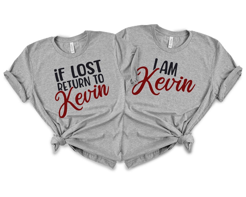May include: Two gray t-shirts with a matching design. One shirt says "if lost return to Kevin" in black and red lettering. The other shirt says "I am Kevin" in black and red lettering.
