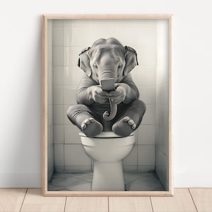 May include: A black and white photo of an elephant sitting on a toilet and looking at a smartphone.
