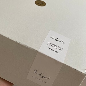 May include: A white box with a sticker that says "Hi Beauty, You have been expecting me, Open me." and another sticker that says "Thank you! Have a nice day."