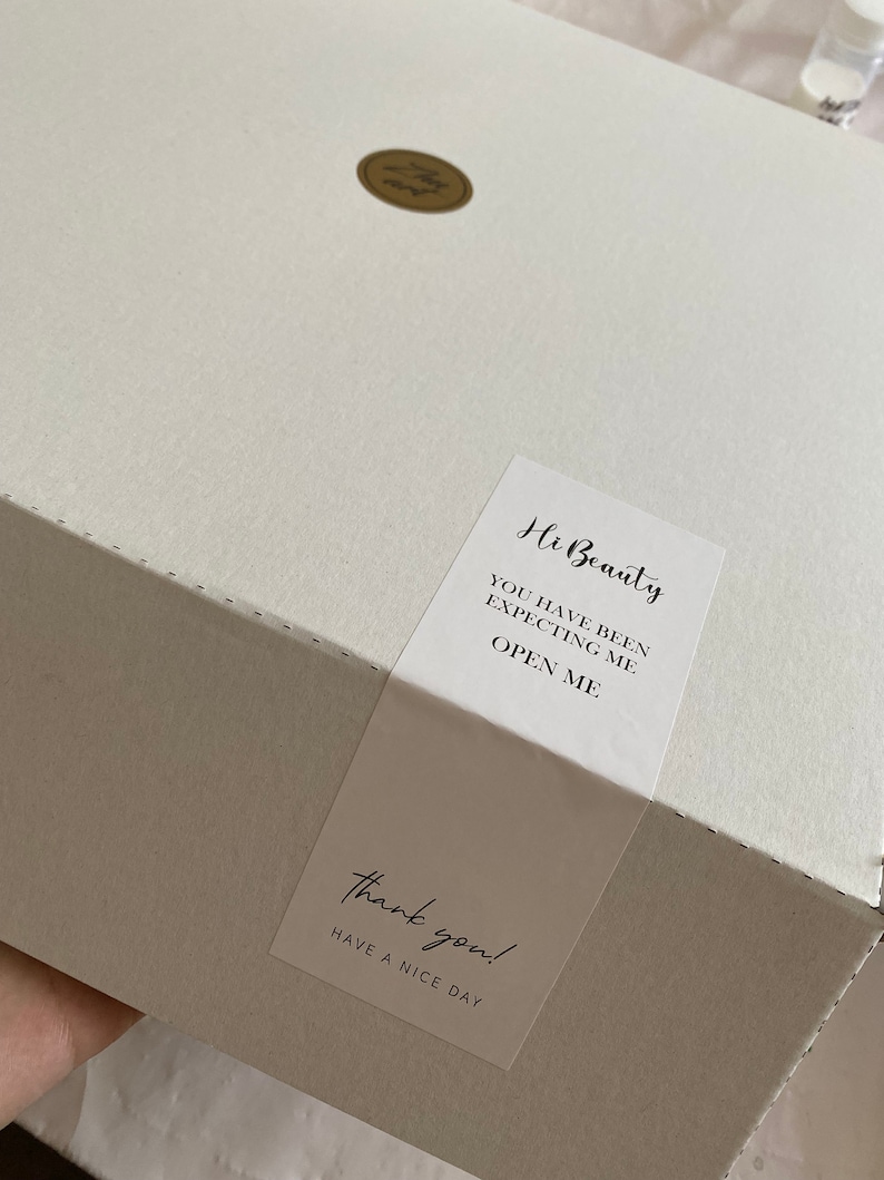 May include: A white box with a sticker that says "Hi Beauty, You have been expecting me, Open me." and another sticker that says "Thank you! Have a nice day."