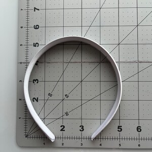 May include: A white headband measuring approximately 5 inches in diameter.
