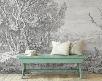 May include: A light green wooden bench with two white throw pillows and a stack of books on top. The bench is in front of a black and white drawing of a landscape with trees and a lake.