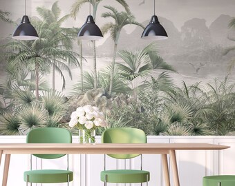 May include: A dining room with a tropical mural wallpaper featuring palm trees and a beach scene. The room has a wooden table with four green chairs and three black pendant lights hanging above the table.