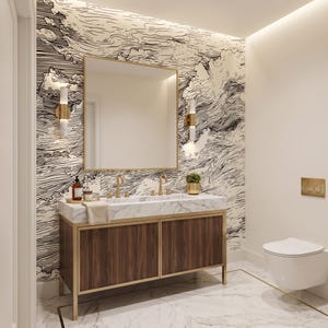 May include: A bathroom vanity featuring a white marble countertop with two gold faucets, a dark wood cabinet with gold trim, and a square mirror. The wall behind the vanity is covered in black and white wallpaper with a swirling wave pattern.