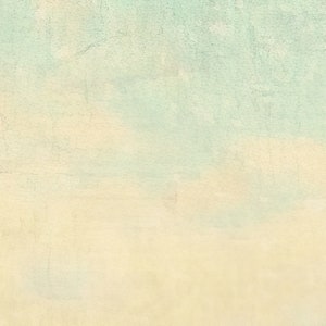 May include: A textured surface featuring a gradient transition from a pale, creamy beige at the bottom to a soft, muted light blue at the top. The overall appearance is reminiscent of a weathered, painted wall with subtle cracks and imperfections.