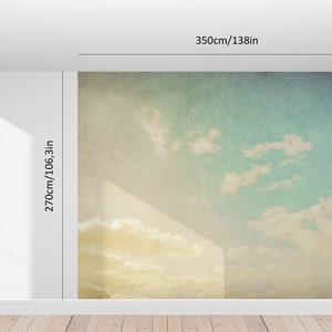 May include: A large wall mural depicting a sky scene with clouds. The mural is 138 inches wide and 106.3 inches high. The sky transitions from a yellow-gold at the bottom to a light blue at the top, with white clouds.