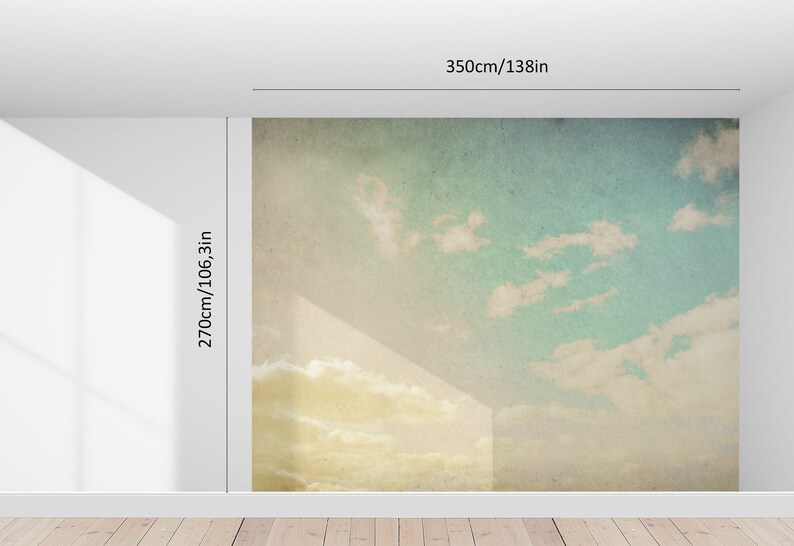 May include: A large wall mural depicting a sky scene with clouds. The mural is 138 inches wide and 106.3 inches high. The sky transitions from a yellow-gold at the bottom to a light blue at the top, with white clouds.