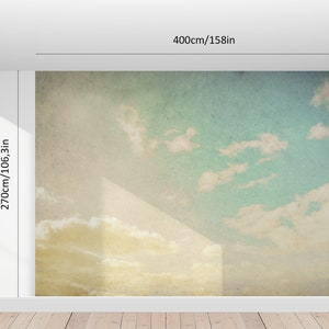 May include: A wall mural depicting a sky scene with clouds, measuring 158 inches wide and 106.3 inches high. The mural features a gradient of colors, transitioning from yellow at the bottom to blue at the top, with white clouds.
