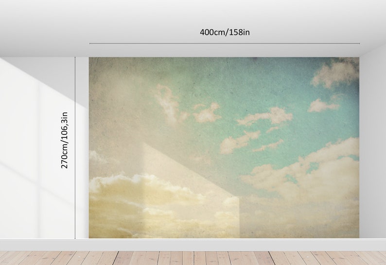 May include: A wall mural depicting a sky scene with clouds, measuring 158 inches wide and 106.3 inches high. The mural features a gradient of colors, transitioning from yellow at the bottom to blue at the top, with white clouds.