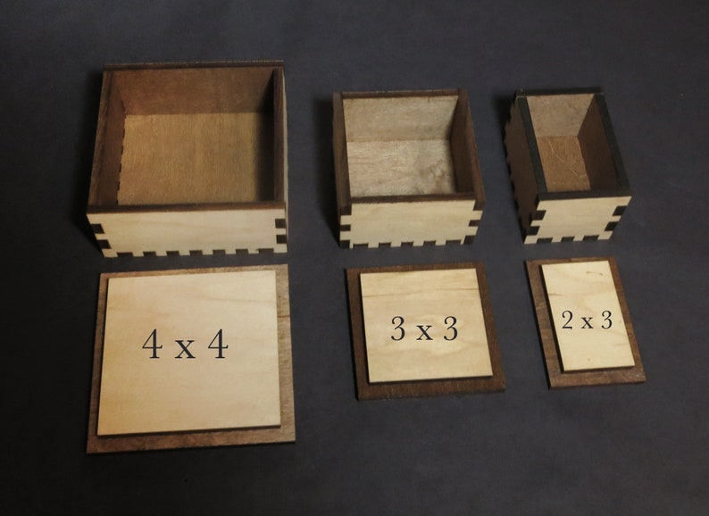 May include: Four wooden boxes with lids, each with a different size. The boxes are labeled with their dimensions: 4 x 4, 3 x 3, and 2 x 3.