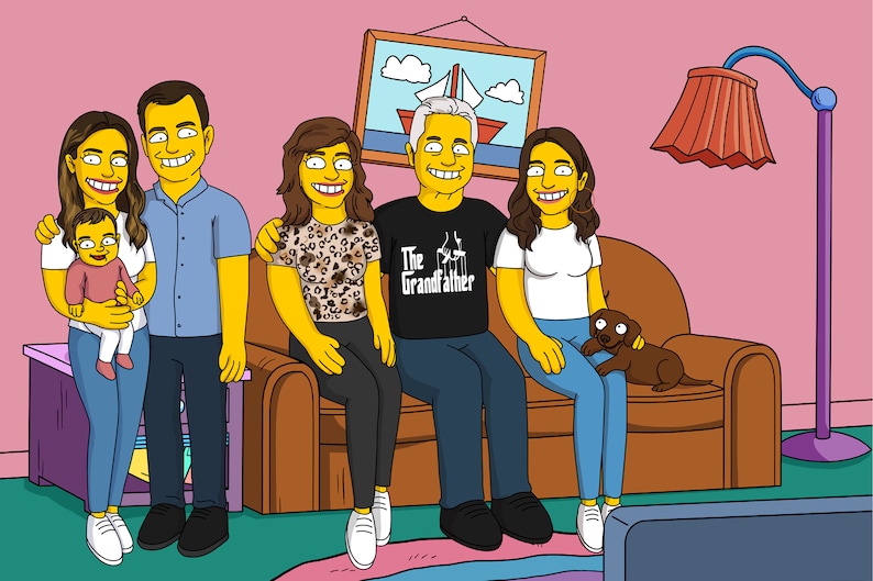 May include: A family portrait featuring a multi-generational group of people, including a baby, two adults, and an older adult. The family is sitting on a brown couch in a living room setting. The older adult is wearing a black t-shirt with the text "The Grandfather" printed on it. The family is smiling and looking at the camera.