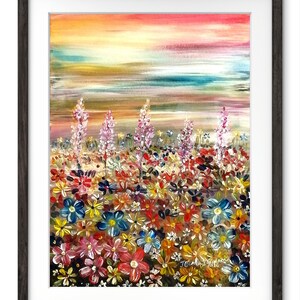 May include: A framed watercolor painting of a vibrant field of flowers under a colorful sunset. The artwork features a variety of colorful blooms in shades of red, blue, yellow, and white, with tall purple flowers. The sky transitions from pink to yellow.