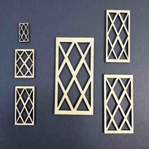 May include: A collection of laser-cut wooden decorative panels with a geometric diamond pattern. The panels vary in size, with the largest measuring approximately 4 inches tall and 2 inches wide. The wood has a natural, unfinished appearance.