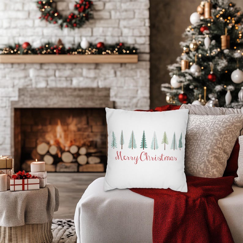 May include: White throw pillow with a row of green Christmas trees and the text "Merry Christmas" in red cursive.