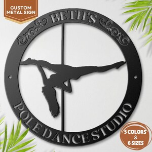 May include: Black metal sign featuring a silhouette of a pole dancer within a circular frame. The text "BETH'S POLE DANCE STUDIO" is displayed around the circle. The sign also includes the text "CUSTOM METAL SIGN" and options for "5 COLORS & 6 SIZES".