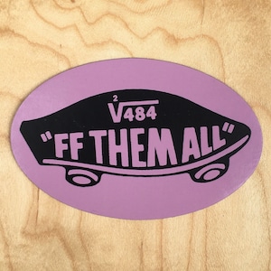 May include: A purple oval sticker with black text and design. The text reads "FF THEM ALL" in bold, white letters. Above the text is the mathematical expression "√484". The sticker is on a light wood surface.