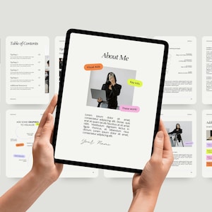 Puede incluir: Una persona sostiene una tableta negra que muestra una página web titulada "About Me" con una foto y texto. La tableta está rodeada de otras pantallas con texto y gráficos. La página web incluye el texto "Visual Aids", "Key Info" y "These work".