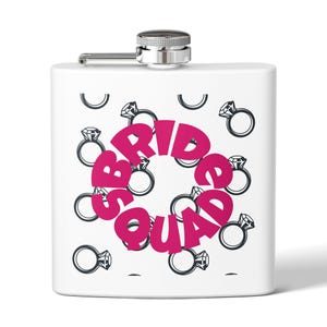 May include: White flask with a silver cap and hinge. The flask is decorated with a pattern of black diamond rings and the words "BRIDE SQUAD" in pink, creating a fun and celebratory design.