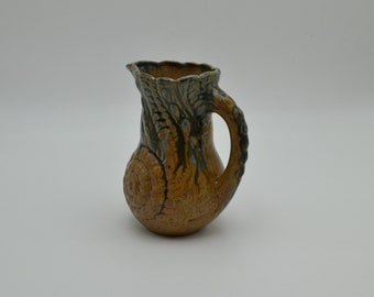 Sandstone pitcher with winding decoration