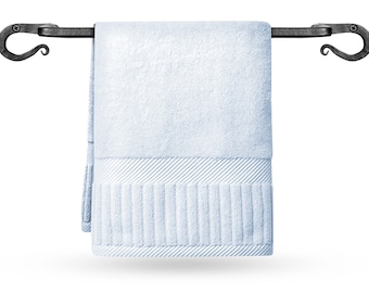 May include: A black metal towel bar with decorative scroll ends, holding a light blue towel.
