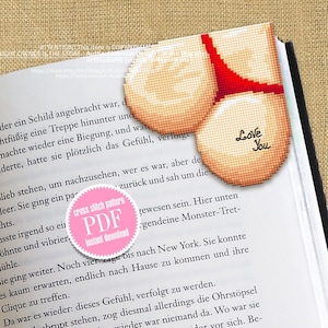 May include: A cross stitch pattern PDF for a heart-shaped bookmark with a red bikini bottom and the words "Love You" in white. The bookmark is on a book with text.