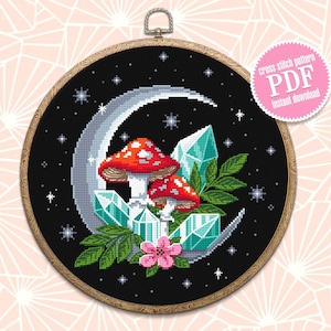 May include: Cross stitch pattern PDF instant download of a crescent moon with two red mushrooms, green leaves, and blue crystals on a black background with white stars.