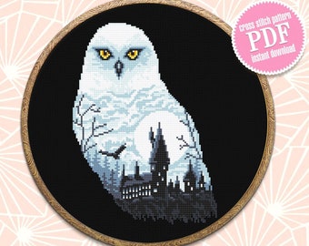 May include: Cross stitch pattern PDF instant download of a white snowy owl with yellow eyes, perched in front of a dark silhouette of a castle.