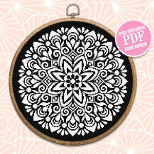 May include: Black and white cross stitch pattern of a mandala design in a wooden embroidery hoop. The pattern is available as a digital PDF download.