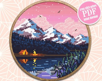 May include: Cross stitch pattern PDF instant download of a mountain lake scene with a pink sky, a campfire, and a tent.